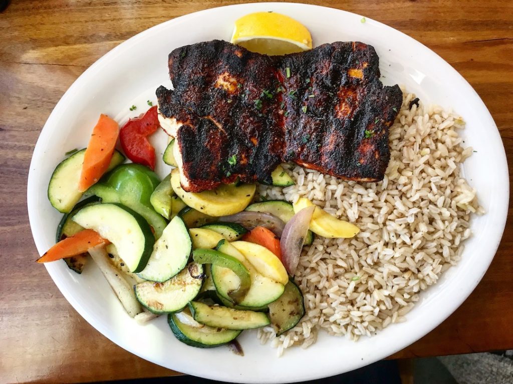 brown rice, veggies, blackened salmon on a plate