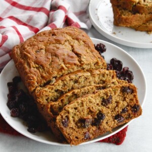 cranberry zucchini bread sliced on a plate