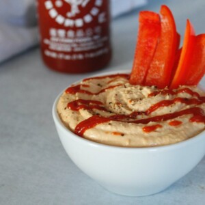 sriracha hummus with fresh red bell peppers