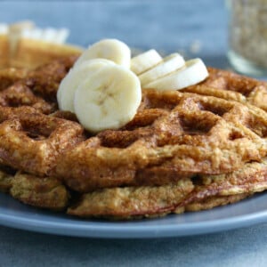 a stack of two banana oat waffles on a blue plate