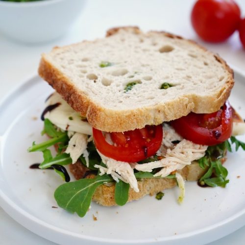 caprese chicken sandwich on a white plate