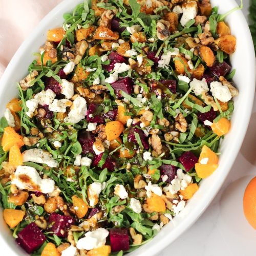 arugula salad with beets next to three clementines
