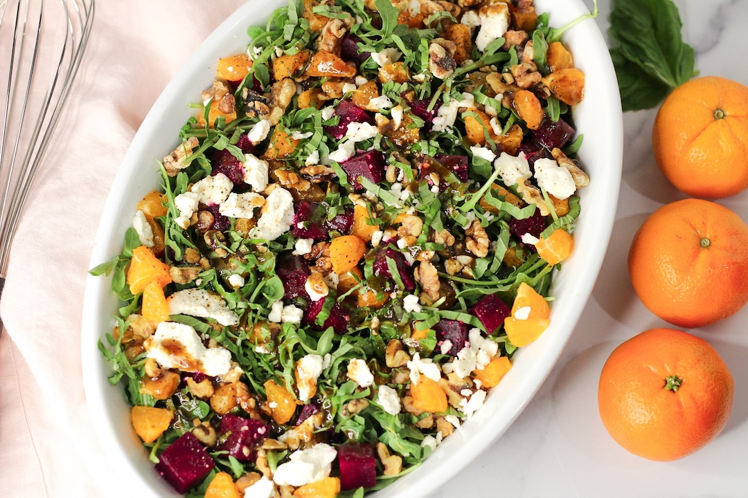 arugula salad with beets next to three clementines
