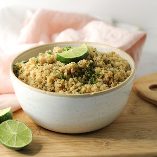 cilantro lime quinoa in a bowl topped with fresh lime