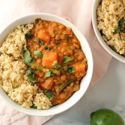 thai green lentil curry with brown rice in a white bowl