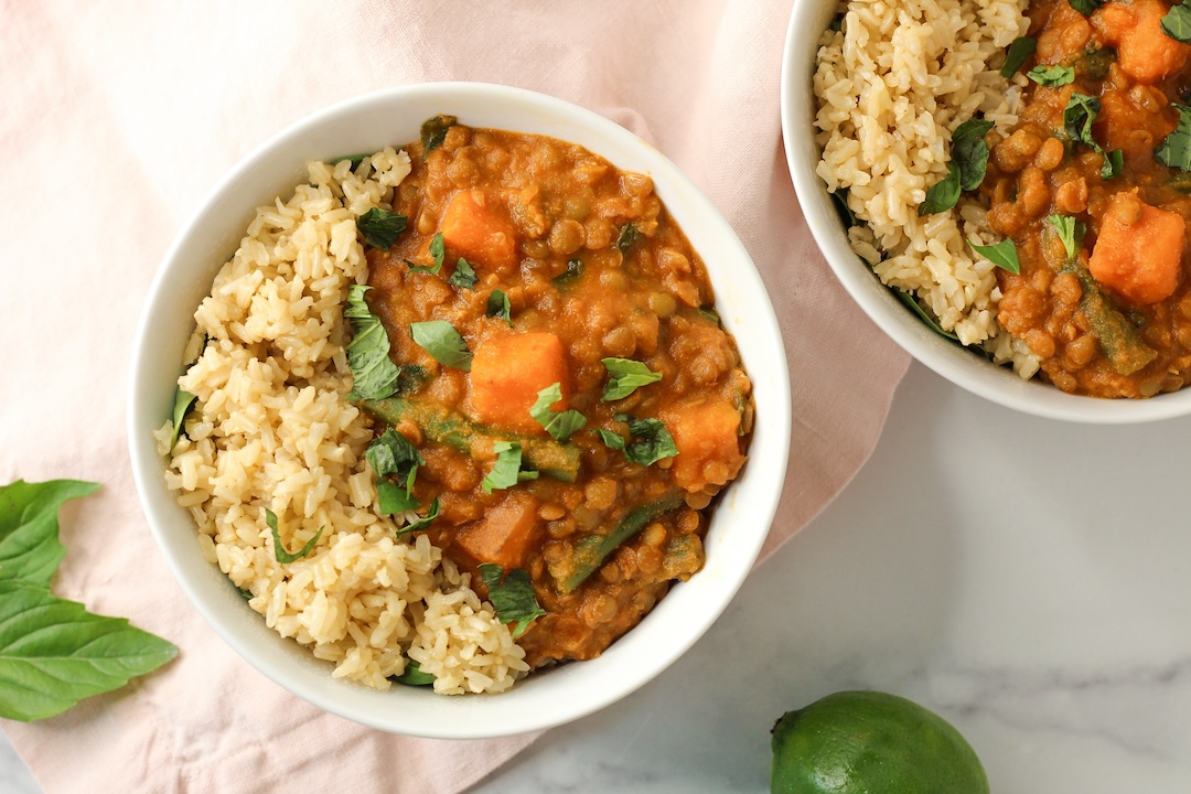 thai green lentil curry with brown rice in a white bowl