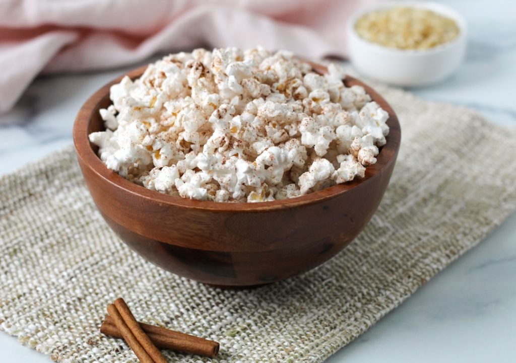 cinnamon sugar seasoned popcorn in a wooden bowl