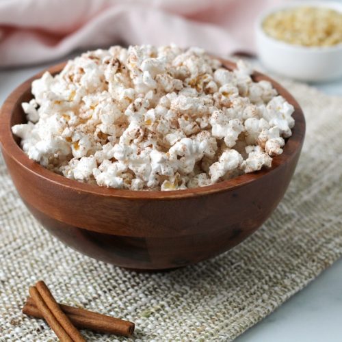 cinnamon sugar seasoned popcorn in a wooden bowl
