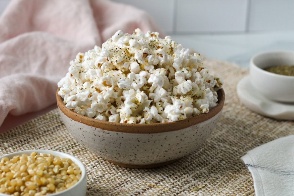 Parmesan popcorn with Italian seasoning in a bowl.