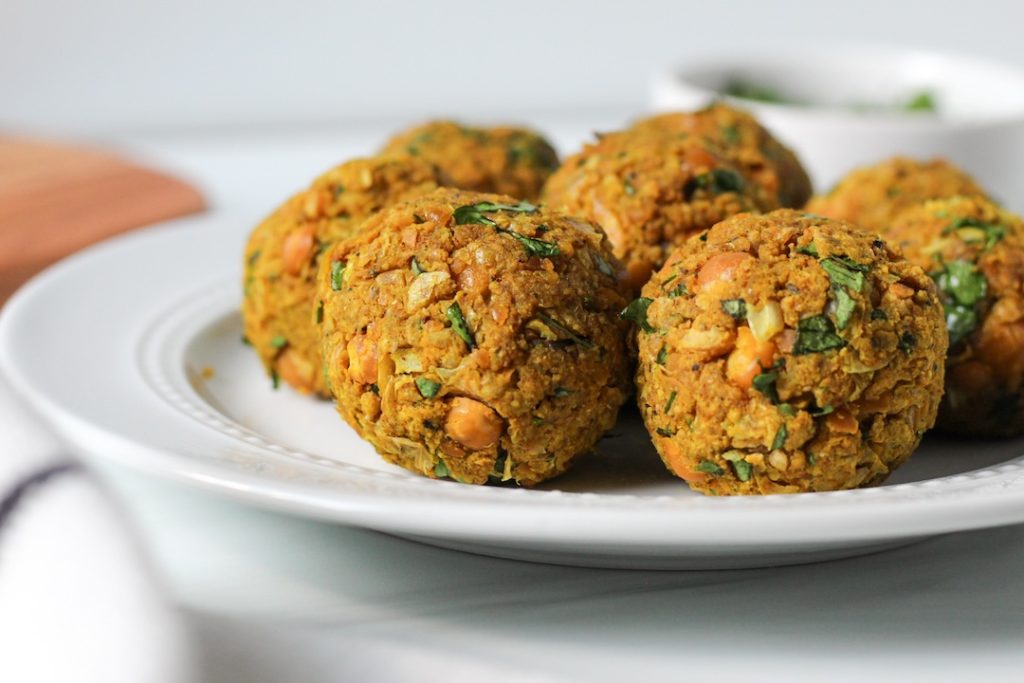 5 chickpea meatballs on a white plate