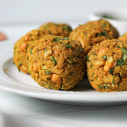 5 chickpea meatballs on a white plate