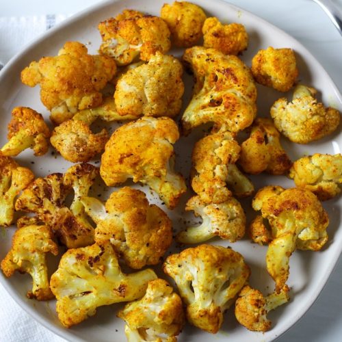 Turmeric roasted cauliflower on a white plate