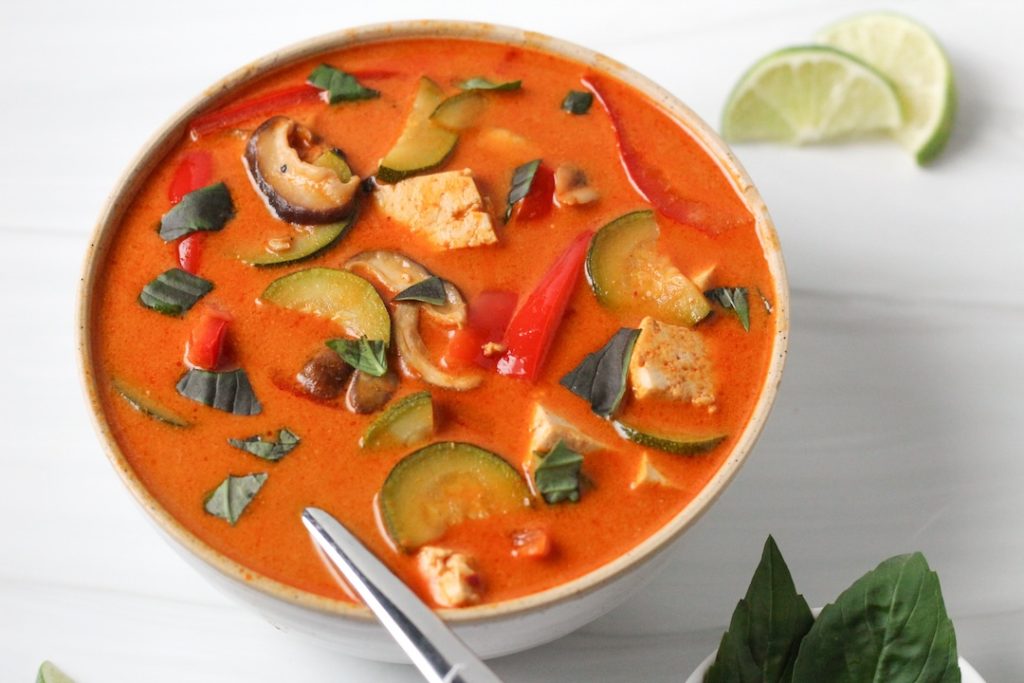 Thai red vegetable curry with mushrooms in a white bowl