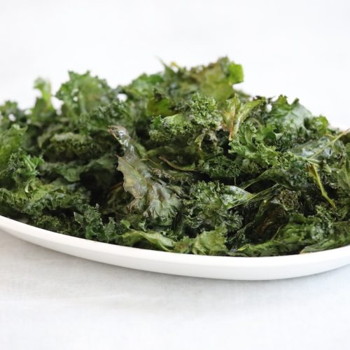 garlic kale chips on a white plate